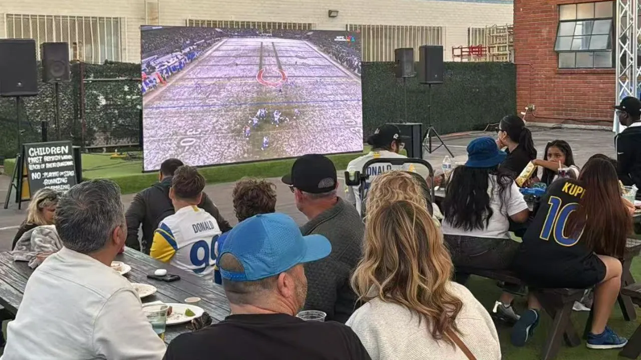 Crowd watching live sport on a 4m x 2m outdoor LED screen — EKINTRY customer project